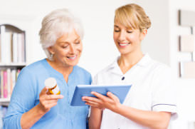 nurse giving the health information of the elderly woman