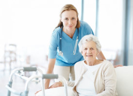 caregiver helping elderly woman